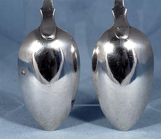 A pair of William IV silver fiddle pattern serving spoons and a similar Victorian pair, Length 237mm, weight 4.9oz/153grms